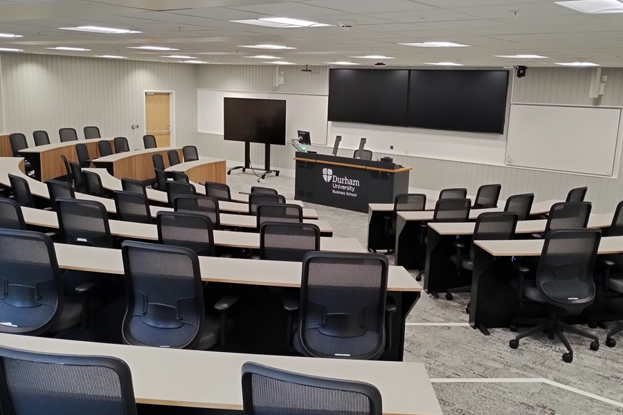 A lecture theatre with curved desks and office chairs