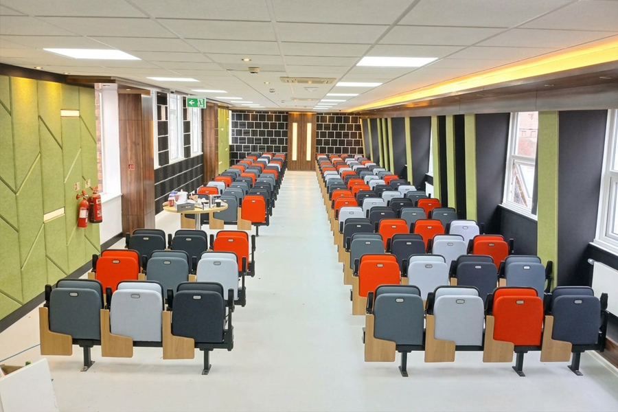 Seats with folding writing tablets in a colourful learning space